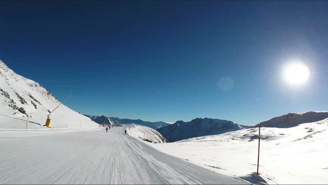 People Snowboarding On Winter Road Surrounded By Snowy Mountains
