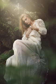 Ethereal woman posing in dreamy forest