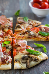 Pizza with salami, mushrooms and herbs