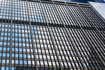 Closeup of glass and concret building.