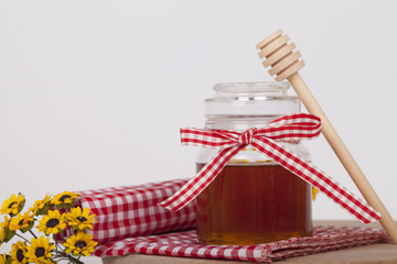 Honey in jar on a wooden background