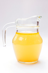 Glass jug of chicken broth isolated on white background