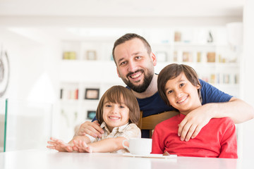 Happy father and son at modern new white home