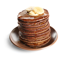 Tasty pancakes with banana and sweet honey on brown plate, isolated on white