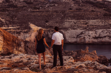 Couple staying in the evening on the seaside