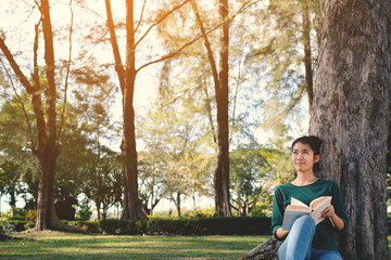 Asian women reading a book in nature and relax time on holiday.