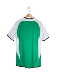 Green Football shirt hanging on hook and isolated on white