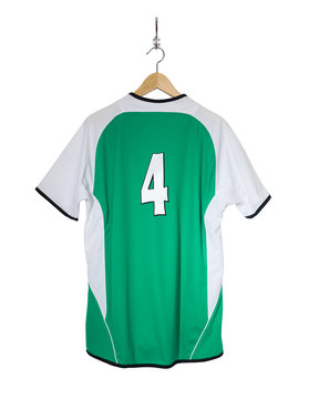 Green Football shirt hanging on hook and isolated on white