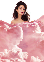 Double exposure of gorgeous woman portrait hiding behind cloudscape