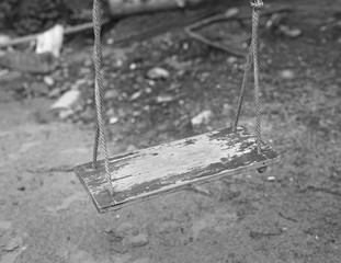 Wooden swing and sand beach background. Black and White tone.