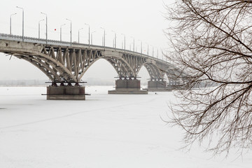 Road bridge over the Volga river in Saratov, Russia. Winter, ice on the river