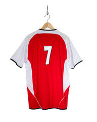 Yellow Football shirt hanging on hook and isolated on white