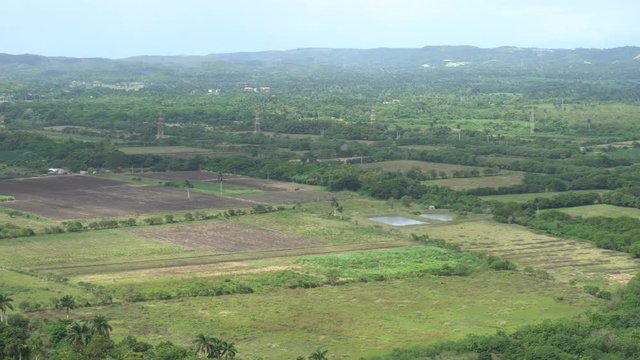 Panoramic view of the tropical valley with fields and hills at summer sunny day
