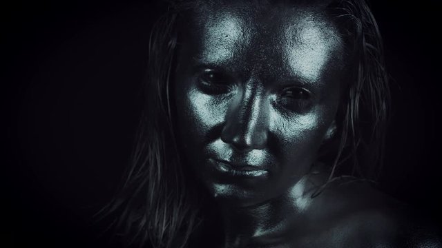 4K Horror Woman with Silver Metallic Make-up Looking at Camera