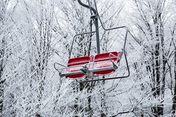 Ski lift with seats going over the mountain 