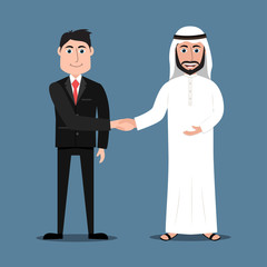 Fototapeta premium Happy Arab man in traditional dress and a western businessman in suit shaking hands
