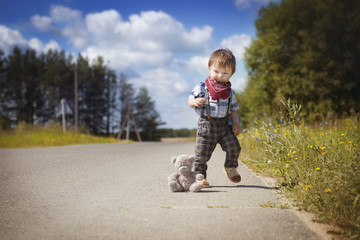 Fototapeta premium Little boy walking in the garden