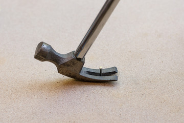 Hammer and nails on wood background