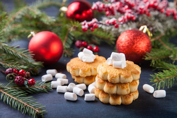 cookies about marshmallows and Christmas balls on a table, selective focus, copy space