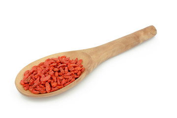 goji berries in wood spoon on white background