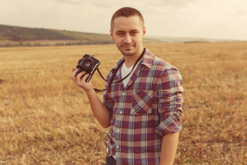 Attractive male photographer outdoors at sunset