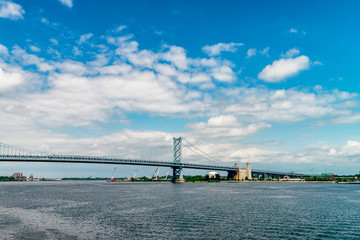 View on Delaware river and Benjamin Franklin Bridge. Bridge – is a suspension bridge across the Delaware River connecting Philadelphia, Pennsylvania, and Camden, New Jersey. 