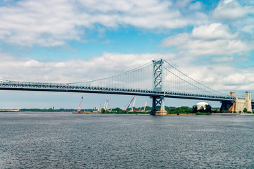 Fototapeta na wymiar View on Delaware river and Benjamin Franklin Bridge. Bridge – is a suspension bridge across the Delaware River connecting Philadelphia, Pennsylvania, and Camden, New Jersey. 