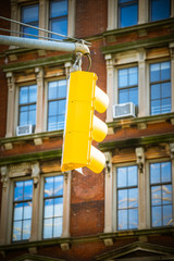 Yellow semaphore hanging on street
