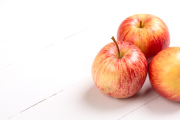 Red fresh apples on wooden table close up, rustic style, selective focus.