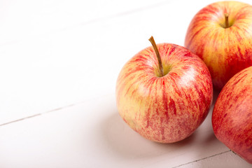 Red fresh apples on wooden table close up, rustic style, selective focus.