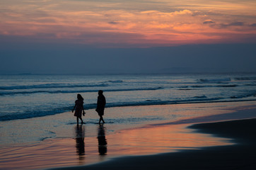 Romantic beach walk at sunset