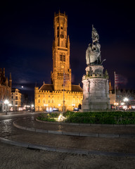 Bruges Market Place and Belfort at night. Wide angle, night view of the central market square in the Belgian town of Bruges, Belgium.