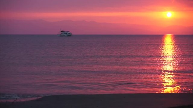 Lonely ship against sea and sunset