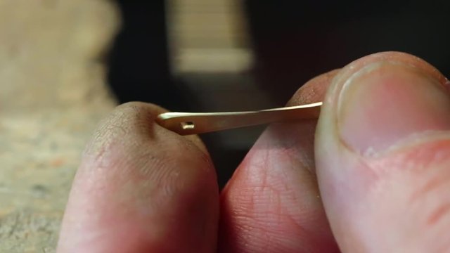 jeweler polishing gold detail. close-up
