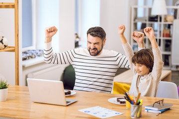 Son and father expressing triumph