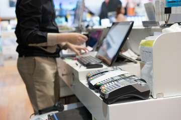 Man using pos terminal at the shop (paying credit card for purch