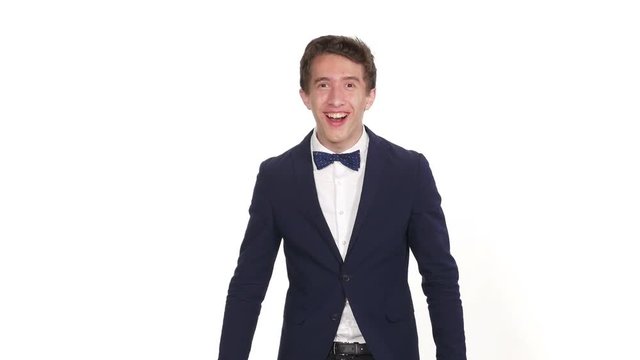 Surprised young businessman standing against white background