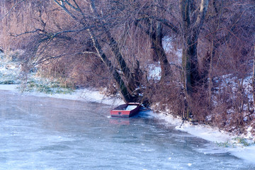 old boat on frozen river