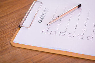 Checklist concept - checklist, paper and a pen with checklist wo