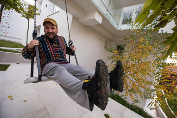 Man living his dream in front of his new modern house