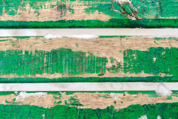 Background picture made of three old green wood boards covered snow.