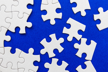 White puzzle elements on a blue background.