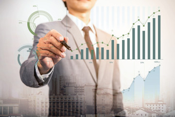 business man writing growth bar chart