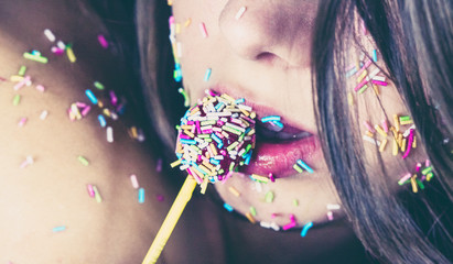 Sweet color lollipop sugar on girl's lips
