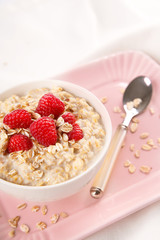 Fototapeta na wymiar Healthy and natural breakfast, oatmeal and raspberries in a bowl