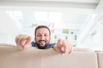 Fototapeta premium Attractive smiling man relaxing at home