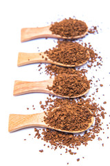 Instant coffee in wooden spoon on white background