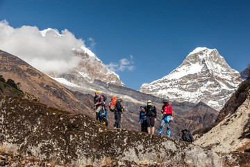 Fototapeta premium Hikers staying on Rock against Mountain Valley and Peaks