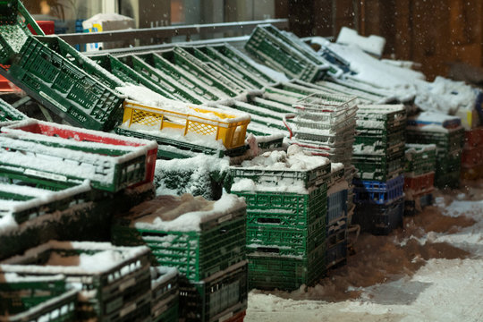 Empty shelves covered in snow in front of food shops in cold winter