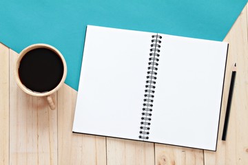 Still life, business, office supplies or education concept : top view image of open notebook with blank pages and coffee cup on wooden background, ready for adding or mock up